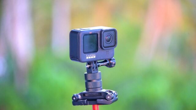 Zbliżenie kamery sportowej GoPro na statywie, w tle rozmyty plener.